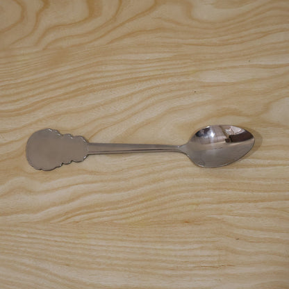 Individually packaged stainless steel carved handle dinner spoon, ideal for gifting.
