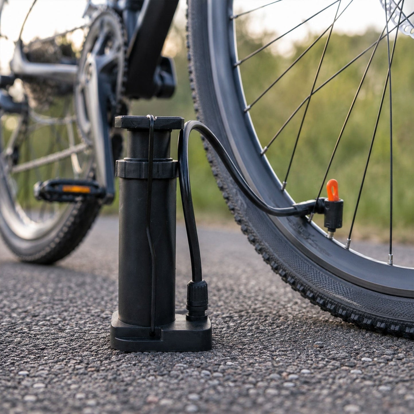 Mini pump inflating football and bicycle tire, versatile nozzles included