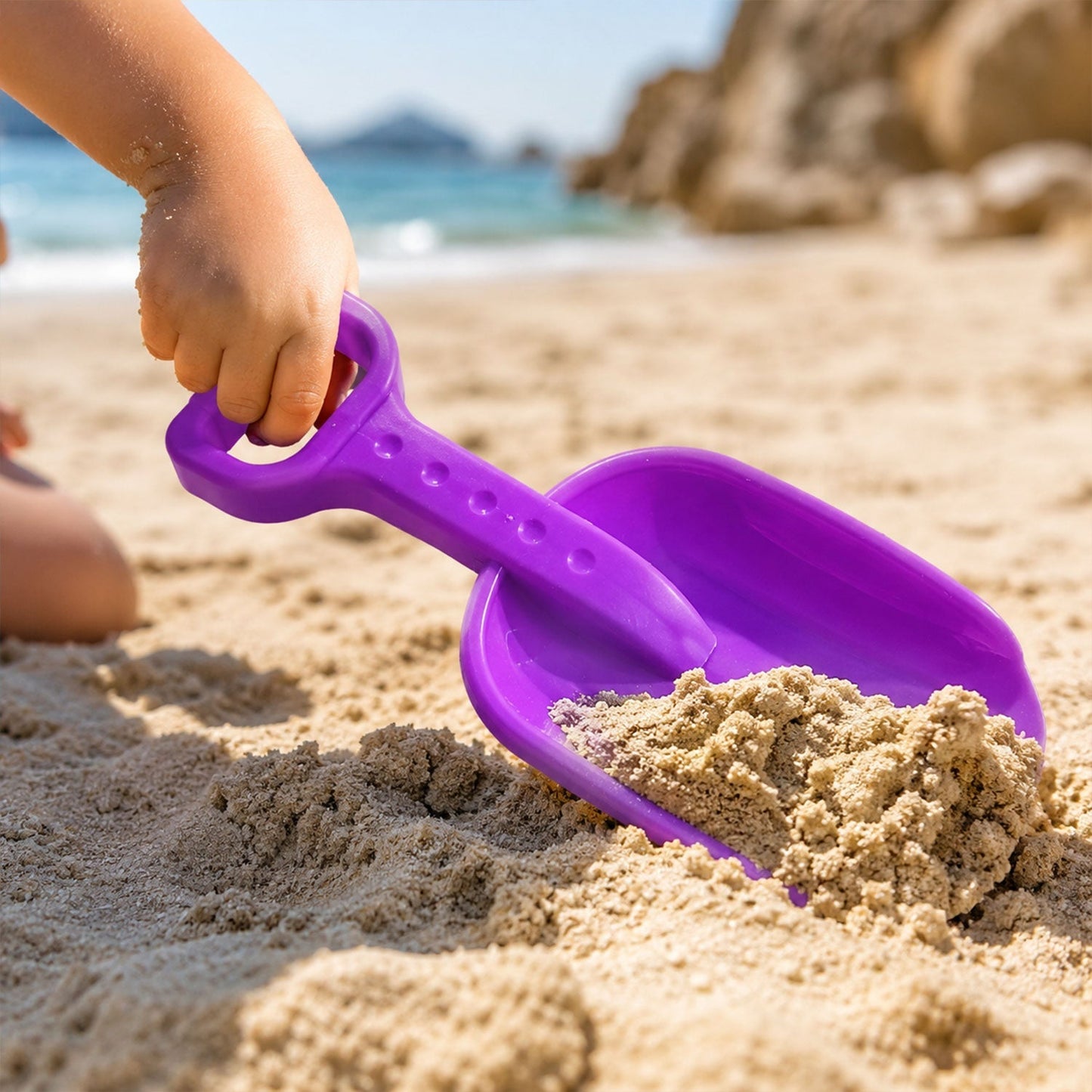Plastic digging spade with rounded edges for safe sand play