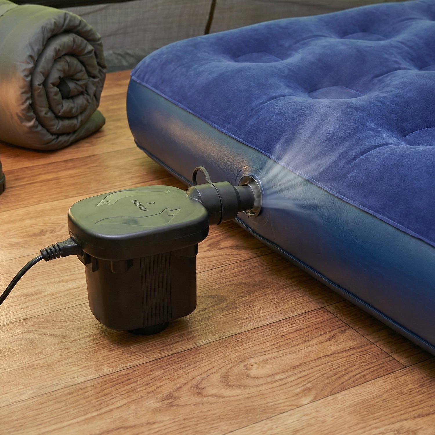 Electric air pump efficiently inflating a vibrant pool float for summer fun.
