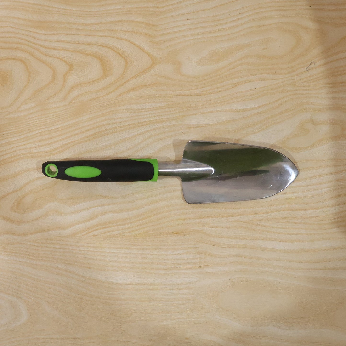 Garden tool in use for planting in flower bed