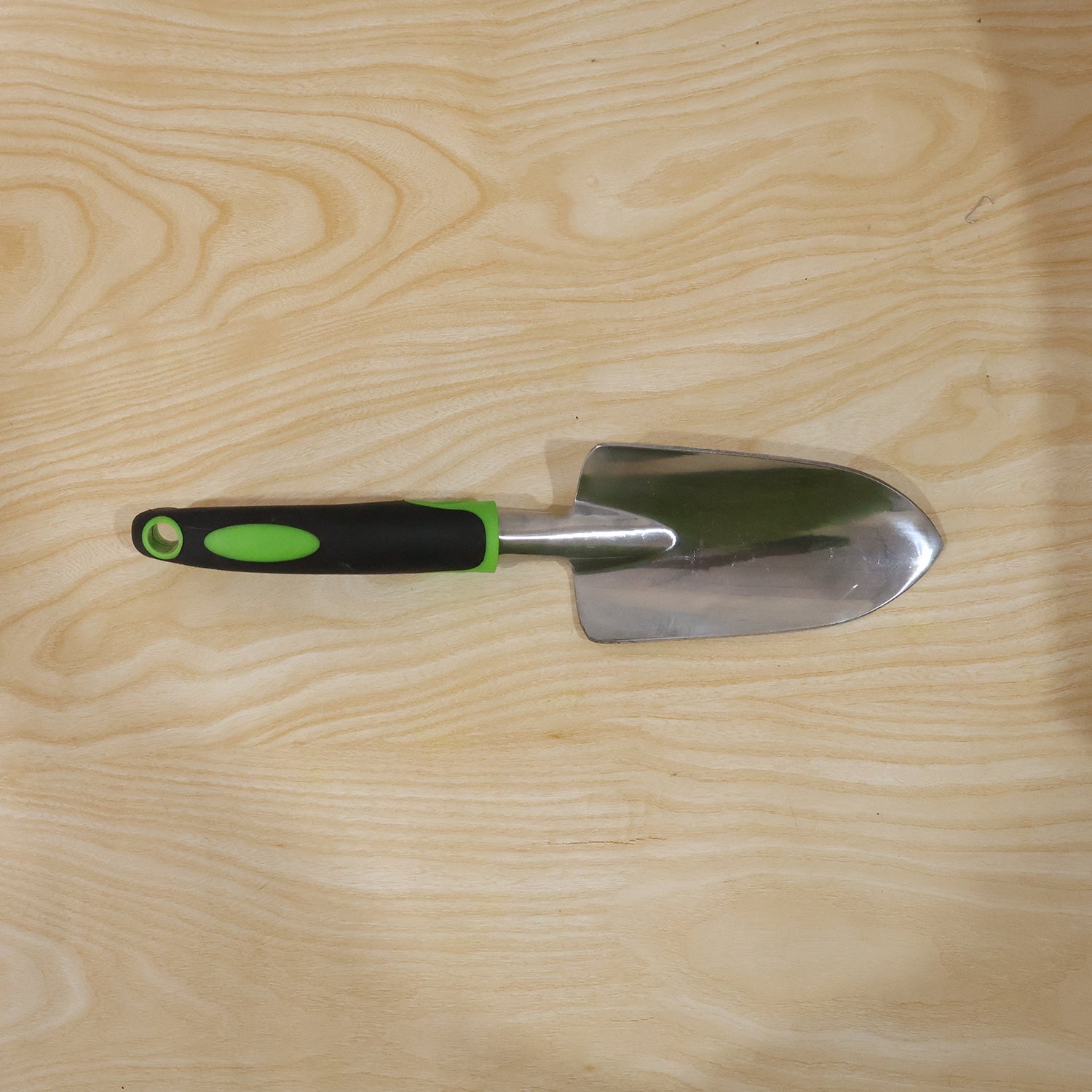 Garden tool in use for planting in flower bed