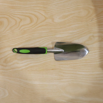 Garden tool in use for planting in flower bed