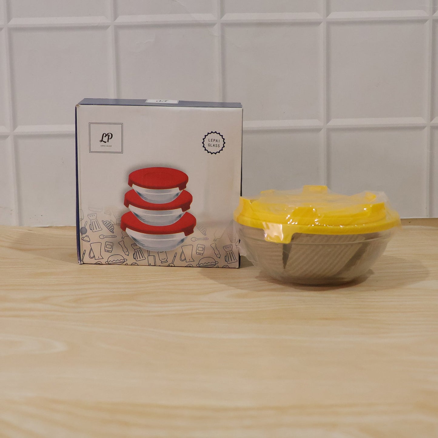 Full view of set of 3 durable, transparent glass bowls with lids.