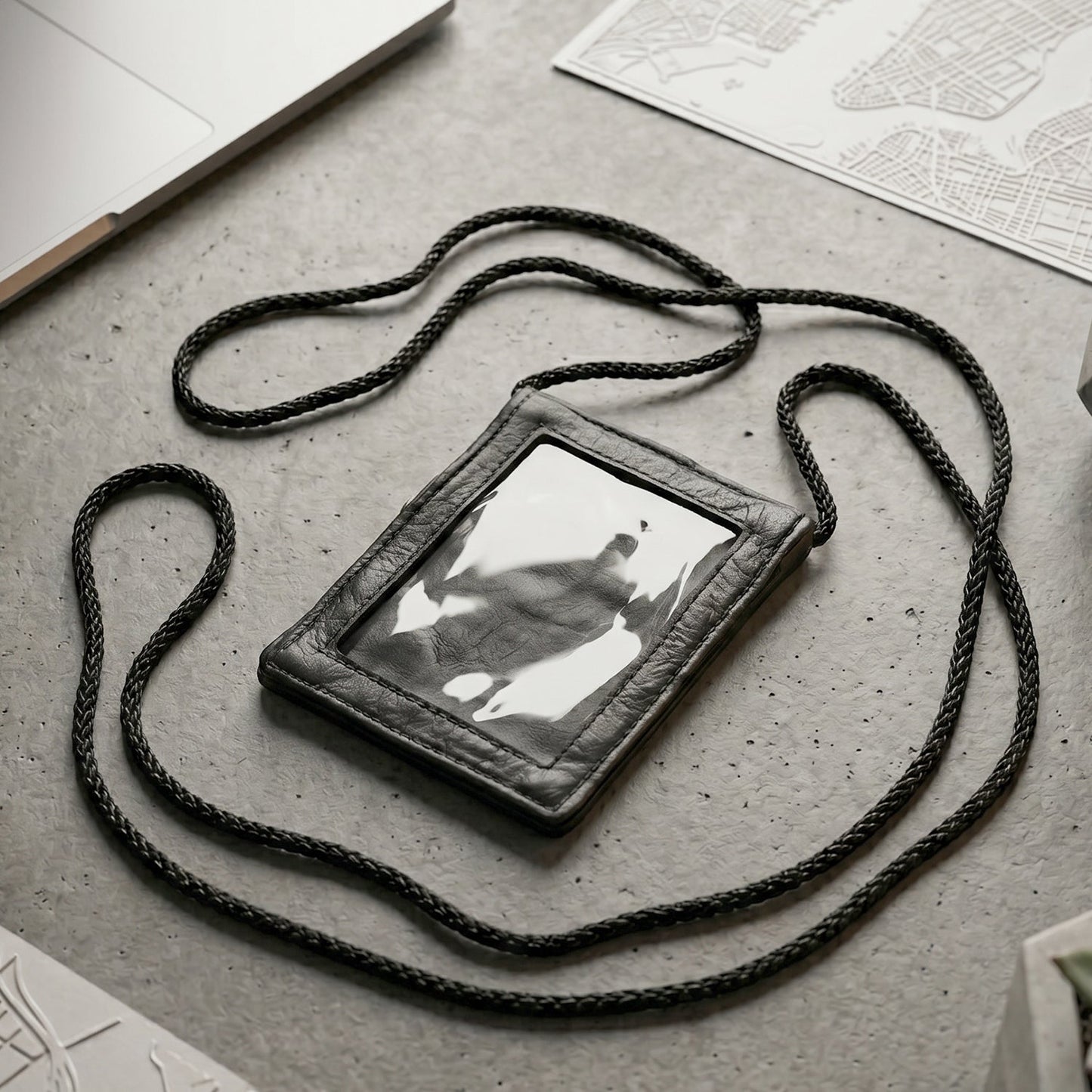 Close-up of the black PU leather neck wallet showing the clear ID window
