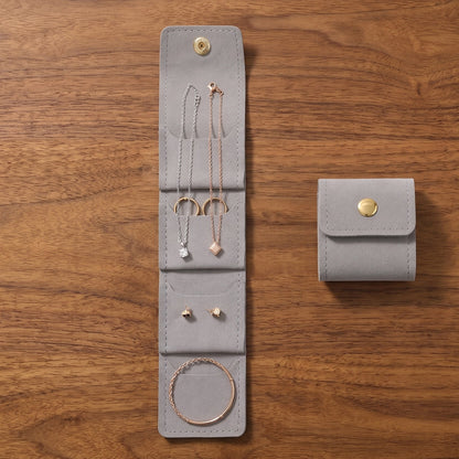Soft travel jewellery bag with compartments and tie closure