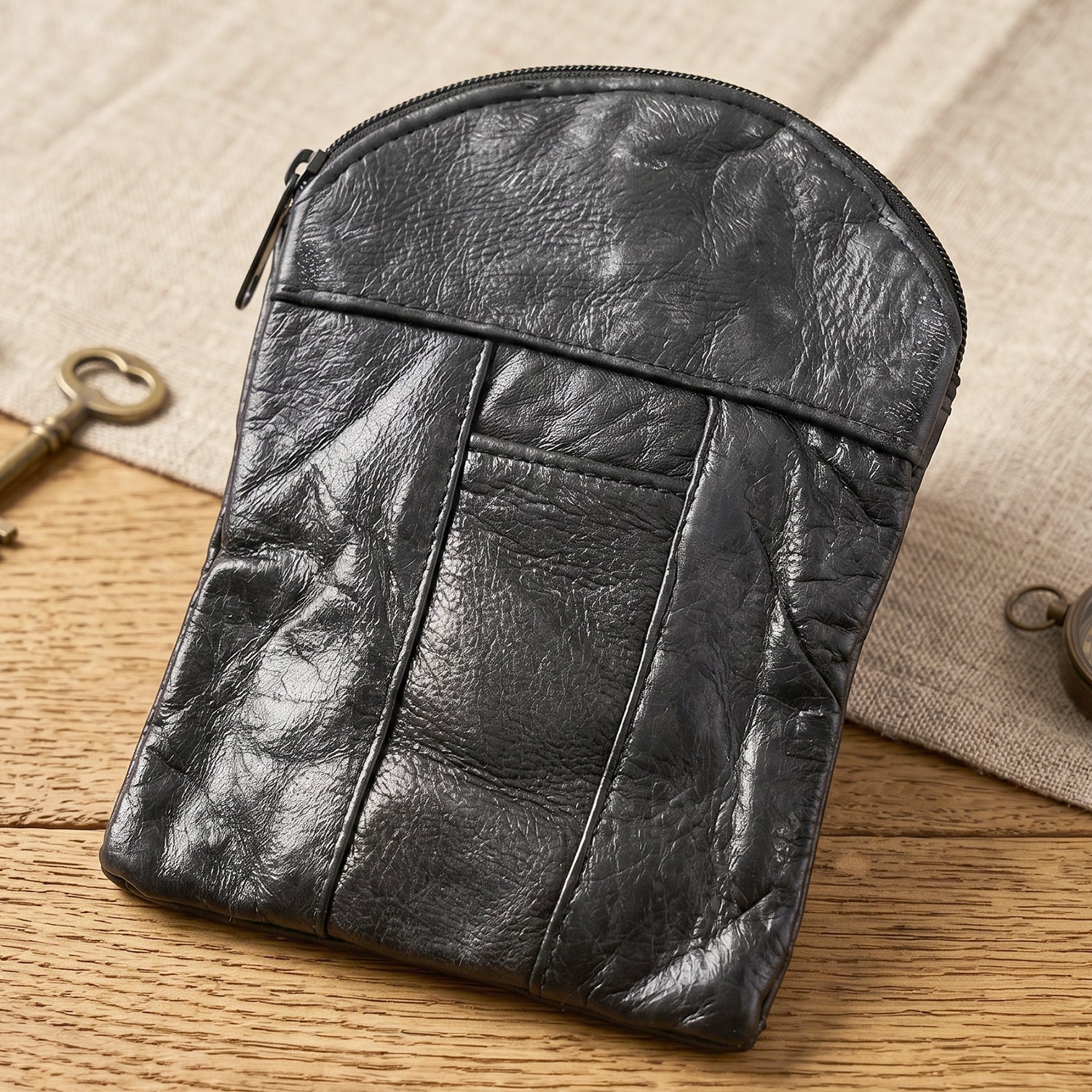 Front view of the compact leather coin pouch with zipper closure.