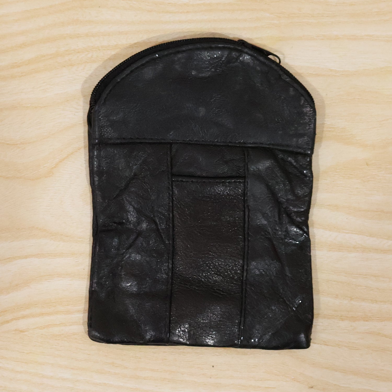 Laying down the black leather mini pouch with its slim profile. Swipeable.