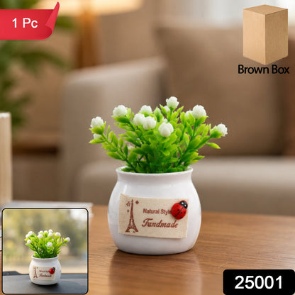 Faux bonsai plant with white flowers in a ceramic pot